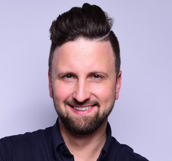 Man with beard smiling professionally